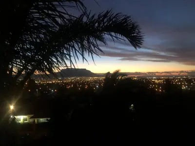 a view of a city lit up at night at Dusk 2 Dawn Self Catering Guest House in Cape Town