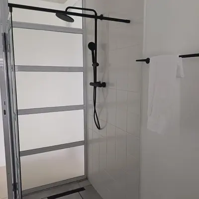 a shower with a glass door in a bathroom at Lanaria 9, Betty's Bay in Clareport