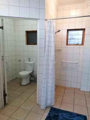 a bathroom with a toilet and a shower in it at The Broad Place in Worcester