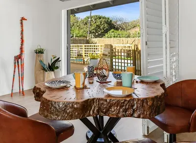 a table made out of a tree stump at Kiefern Haus Main House in Cape Town