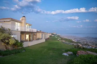a view of a house with a green lawn at House 12 Beach Club in Hermanus
