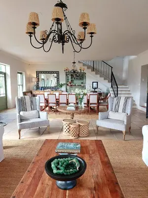 a living room with a chandelier and a table at Moya's Vineyard in Mosselrivier