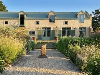 a house with a pathway leading to the front yard at Moya's Vineyard in Mosselrivier
