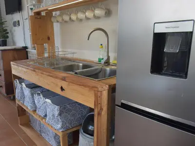 a kitchen with a sink and a refrigerator at Seaview on 2822 - Romantic Ocean Studio in Bettyʼs Bay