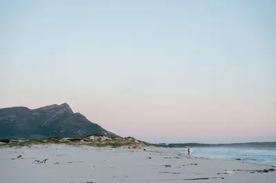 a person standing on a beach near the ocean at Flock-Inn in Fisherhaven