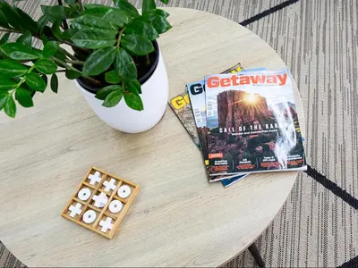 a table with a book and a domino game at La Dolce Vita Gordon’s Bay in Gordonʼs Bay