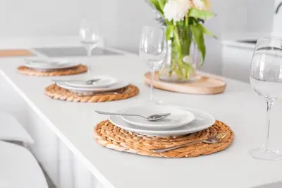 a white table with plates and wine glasses on it at Leisure Bay 117 in Cape Town
