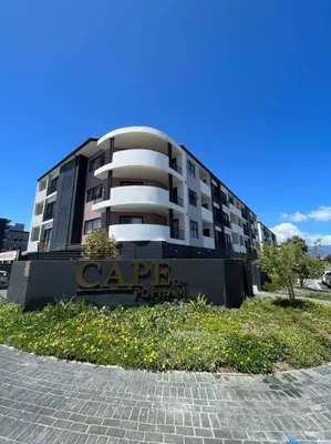 a large building with a sign in front of it at Sunny Beach Apartment with Sea & Mountain Views in Cape Town