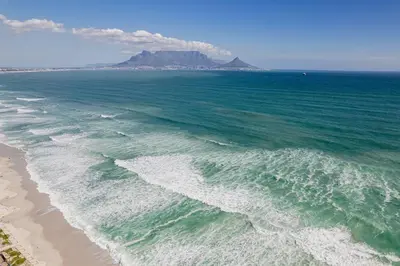 an aerial view of a beach with a mountain in the background at Beach & Sea View Facing Apartment Japanese Styled in Cape Town