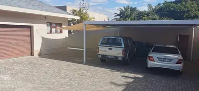 a car parked in a garage next to a house at Mila's at Panorama in Panorama