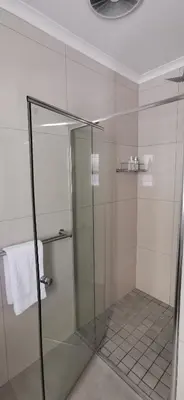 a shower with a glass door in a bathroom at Mila's at Panorama in Panorama
