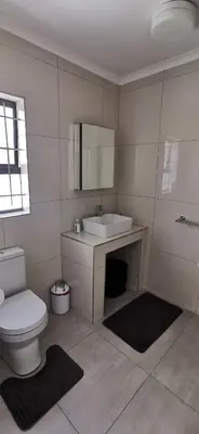 a bathroom with a white toilet and a sink at Mila's at Panorama in Panorama