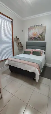 a bedroom with a bed with a painting on the wall at Lasai Accommodation in Worcester