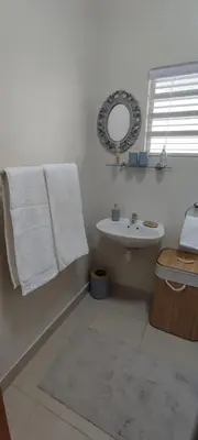 a white bathroom with a sink and a mirror at Lasai Accommodation in Worcester