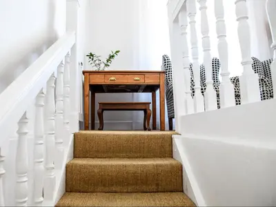 a stairway with a wooden table and a desk at Petites Bulles Lodge in Stellenbosch