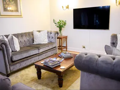 a living room with two couches and a coffee table at Petites Bulles Lodge in Stellenbosch