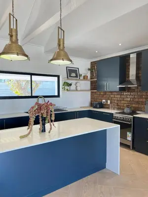 a kitchen with blue cabinets and a blue counter top at Chasselas Self Catering in Cape Town