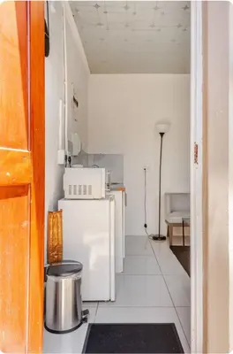 a kitchen with a white refrigerator and a stove at A Room with private Entrance in Cape Town