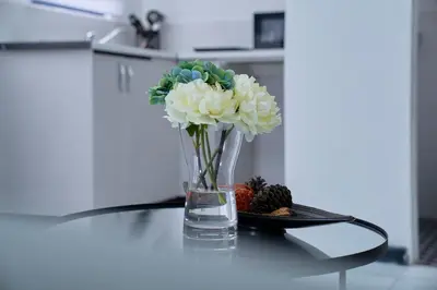 a vase filled with flowers on a table at Blomtuin Sleep and go room in Cape Town