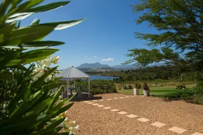 a garden with a gazebo and a lake at Piece of Paradise in Cape Town