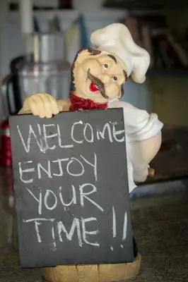 a figurine of a chef holding a sign at Piece of Paradise in Cape Town