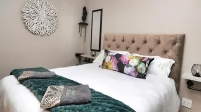 a bedroom with a bed with two pillows at Royal Beauty in Paarl