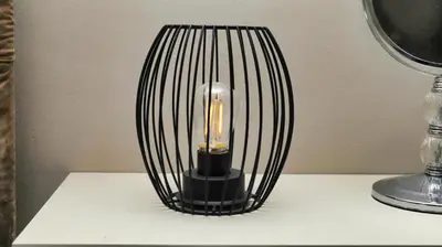 a black lamp sitting on top of a table at Royal Beauty in Paarl