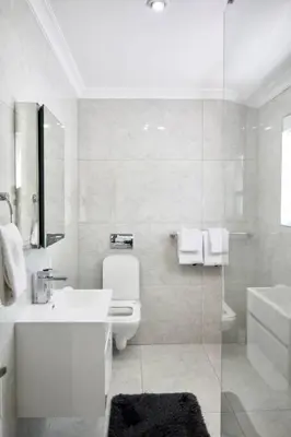 a bathroom with a sink and a toilet and a shower at Olive Grove on Provident in Cape Town