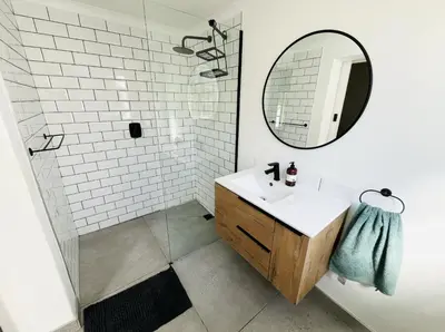 a bathroom with a sink and a mirror at Rondebosch Cottage in Cape Town