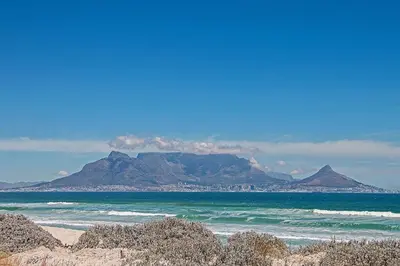 a view of the ocean with a mountain in the background at Beach Break Two in Cape Town