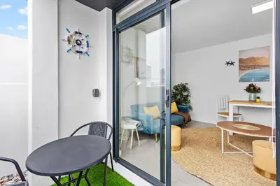 a room with a table and chairs and a room with a table at Beach Break Two in Cape Town