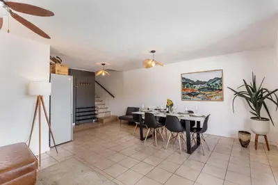 a dining room with a table and chairs in a room at Silvertree Collective Spacious Central Apartment in Stellenbosch