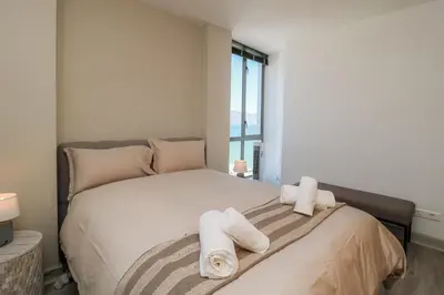 a bedroom with a bed with towels on it at 1402 Hibernian Towers Luxury Self Catering Apartment Strand Western Cape South Africa in Cape Town
