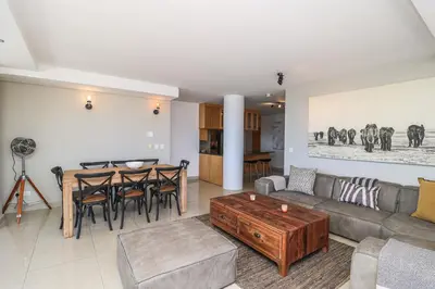 a living room with a couch and a table at 1402 Hibernian Towers Luxury Self Catering Apartment Strand Western Cape South Africa in Cape Town