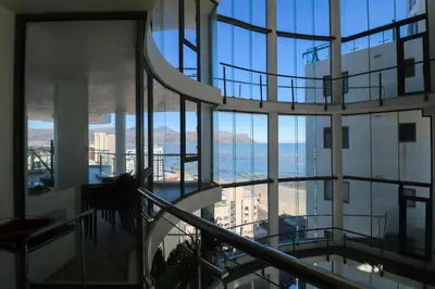 a view of the ocean from a building at 1401 Hibernian Towers Luxury Self Catering Apartment Strand Western Cape South Africa in Cape Town