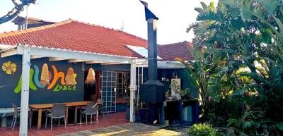 a restaurant with a table and chairs outside of it at Aloha Lodge in Cape Town