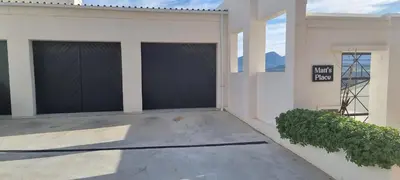 a garage with two black garage doors on a building at Matt's Place in Cape Town