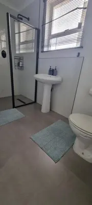 a bathroom with a white sink and a toilet at Matt's Place in Cape Town
