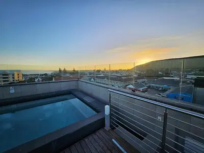a swimming pool on the roof of a building at Central - Whale Watching Paradise -Self check in in Hermanus