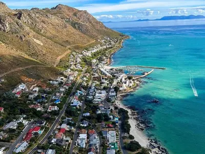 an aerial view of a town next to the ocean at 'Kaya Moya' - Luxury Suite for 2 with Ocean Views in Gordonʼs Bay