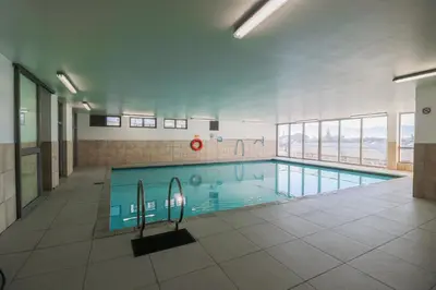 a large swimming pool in a building at 506 Hibernian Towers Luxury Self Catering Apartment Strand Cape Town South Africa in Cape Town