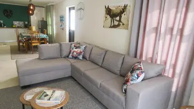 a living room with a couch and a table at Sonvanger 3 in Paarl