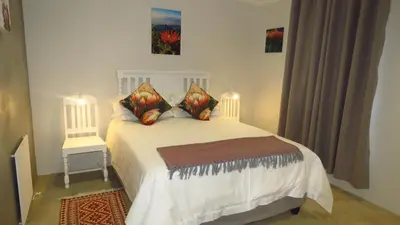 a bedroom with a white bed with two pillows at Sonvanger 3 in Paarl