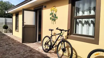 a bike parked outside of a yellow house at Sonvanger 3 in Paarl