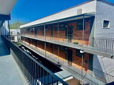 a building with a balcony on the side of it at 2 Bedroom Apartment On Dorp St - Prime Location in Stellenbosch