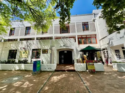 a white building with a tent in front of it at 2 Bedroom Apartment On Dorp St - Prime Location in Stellenbosch