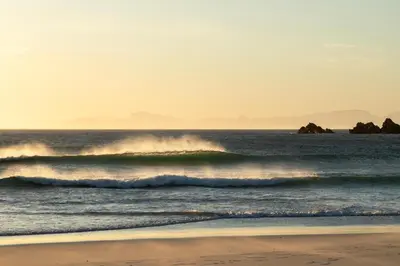 two waves in the ocean on a beach at Fijnbos in Pringle Bay