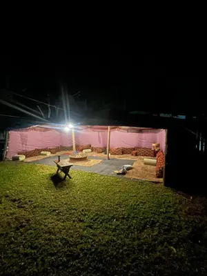 a park lit up at night with a bench in the grass at STAY In TEHAMA in Cape Town