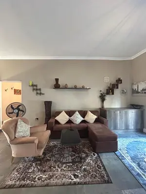 a living room with a couch and a rug at STAY In TEHAMA in Cape Town