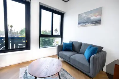 a living room with a couch and a table at Bridgewater Studio Apartment in Century City